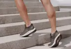 Stock photo of a person runnnig up stone steps outside in running sneakers.