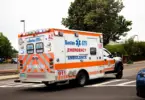 Stock photo of an American ambulance racing down a street.