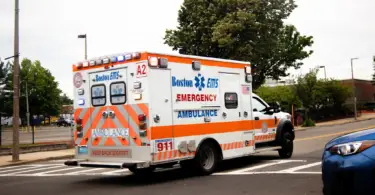 Stock photo of an American ambulance racing down a street.