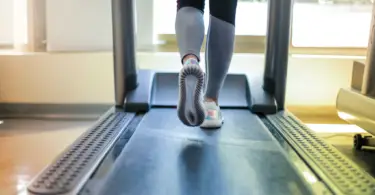 Stock photo of a person walking on a treadmill.