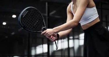 Stock photo of a woman playing pickleball.