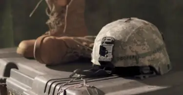 Stock photo of a military helmet, dog tags, and tactical boots.