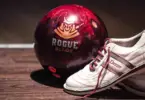 Stock photo of a red bowling ball and white Dexter bowling shoes.