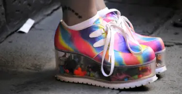 Stock photo of someone's feet in rainbow platform shoes.
