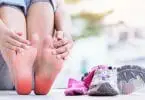 Woman sitting besides best running shoes for plantar fasciitis performing toe flex stretches for plantar.