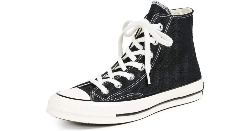 Product photo of onverse Chuck Taylor All-Star shoe, black with white outsole and white laces.