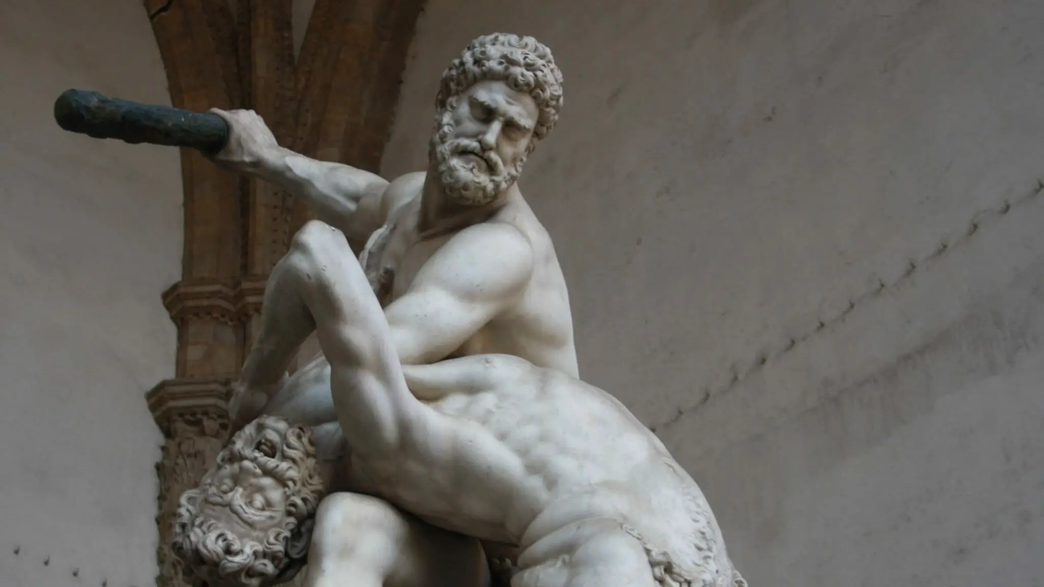 Wrestling history in ancient Greece seen in statue of a man wrestling with a centaur.