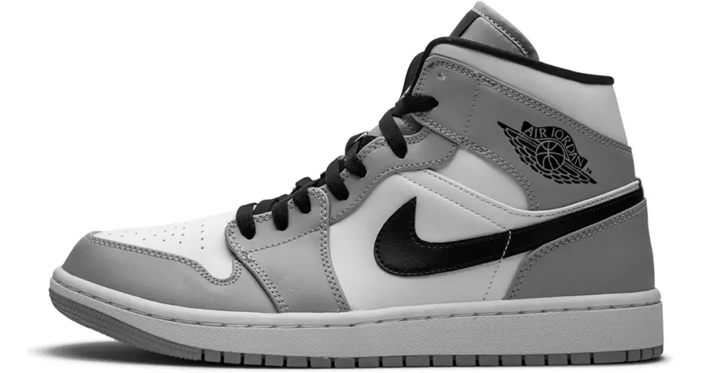 Product photo of Air Jordan 1 Mid basketball shoe, white and gray with Air Jordan basketball loto on upper side and black Nike swoosh on side.