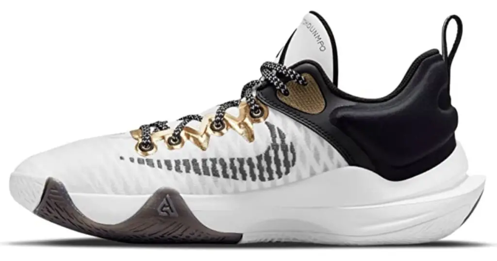 Product photo of Nike Giannis Immortality, white with gold detailing on laces eyelets, black Nike swoosh on the side, white sole and black around the space for the foot.