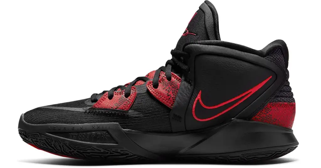 Black Nike Kyrie Infinity basketball shoe with red detail on heel and lacing area, and red Nike swoosh on the side.