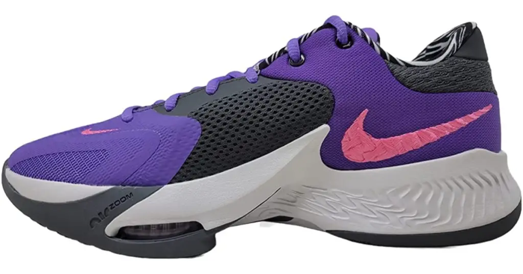 Black and purple sneaker with white sole and pink Nike swoosh on the side.