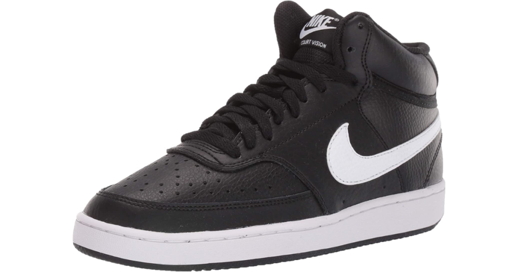 A chunky, rounded black shoe with a large white Nike swoosh on the side, black laces, and white, flat sole. The Nike logo and name is on the tongue in white.
