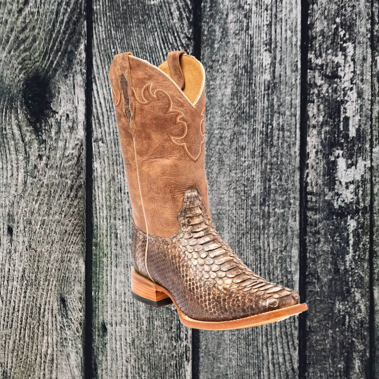 Snakeskin cowboy boot on weathered wood background.