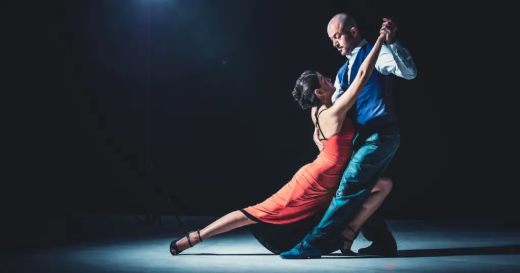 Stock image of two people dancing in a spotlight.