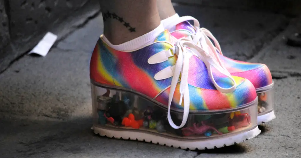 Stock photo of a person wearing rainbow platform sneakers.