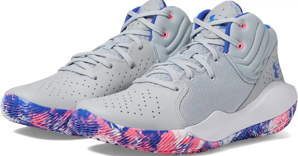 Closeup of Under Armour Jet ‘21 Basketball Shoes, light gray with pink and gray detail on upper and Under Armour symbol. Soles are marbled pink, blue, and white.