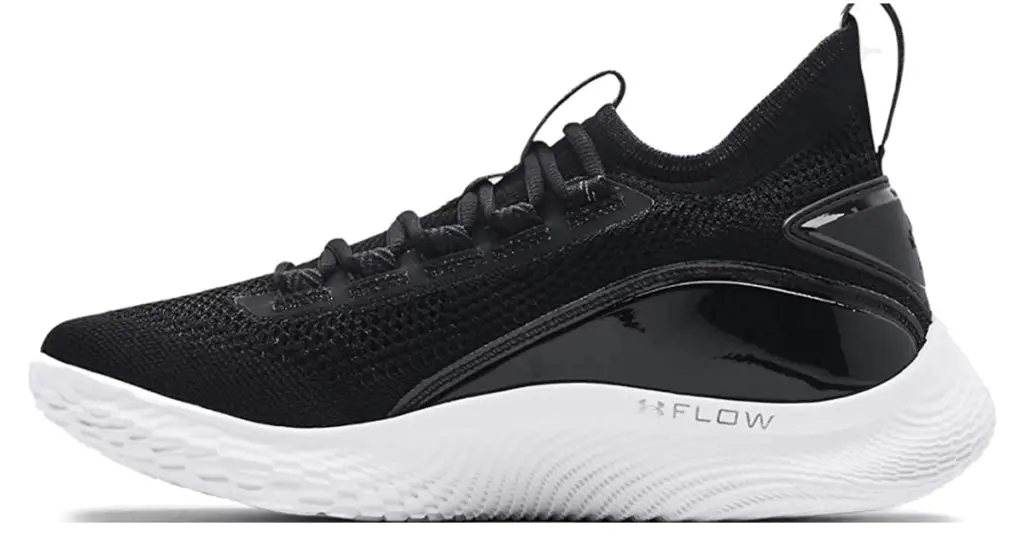 Black Curry 8 basketball shoe with white sole. Under Armour logo and text "FLOW" is written in soft gray on the side of the sole.