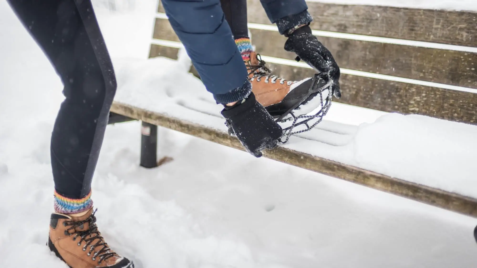 Woman putting on nano spike best ice cleats for traction in the snow