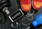 Zumba shoes featured with blue water bottle and iPhone and dumbbell